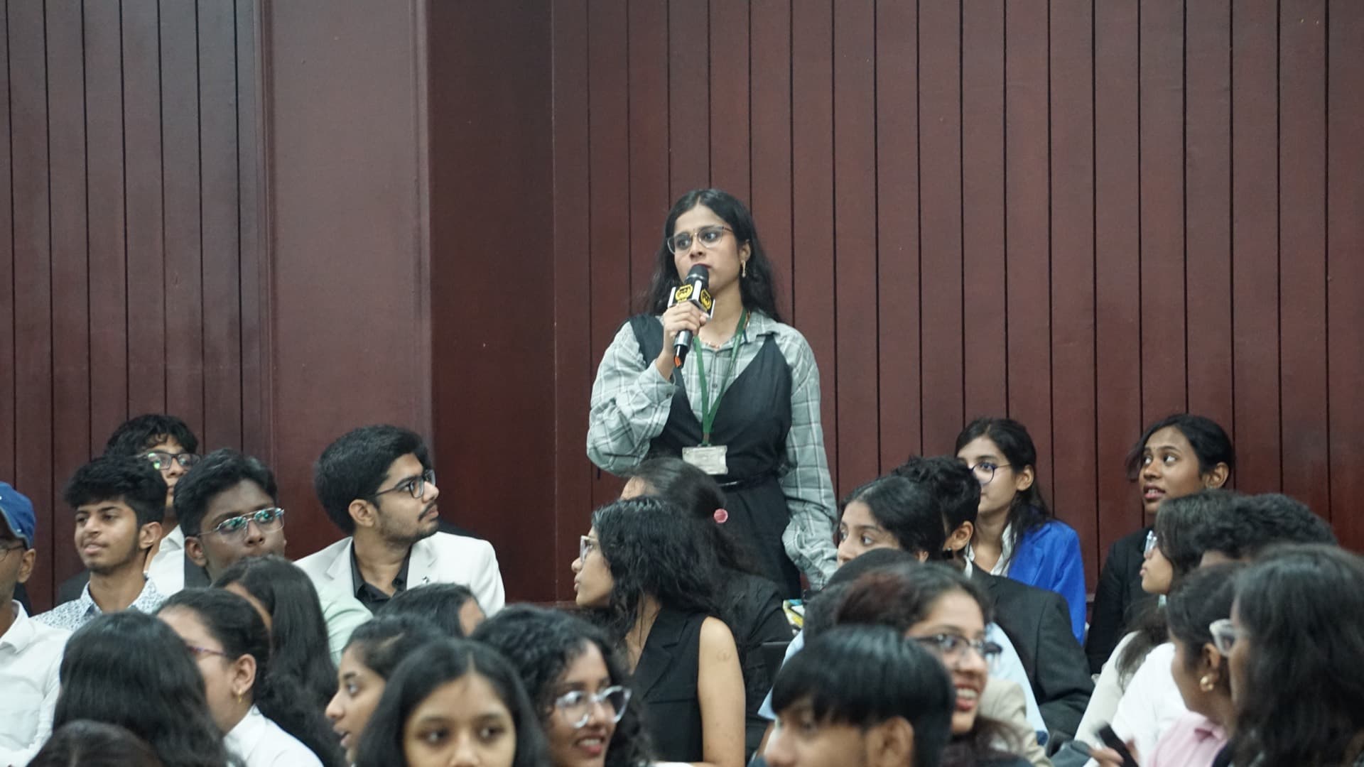 A delegate addressing committee with a microphone