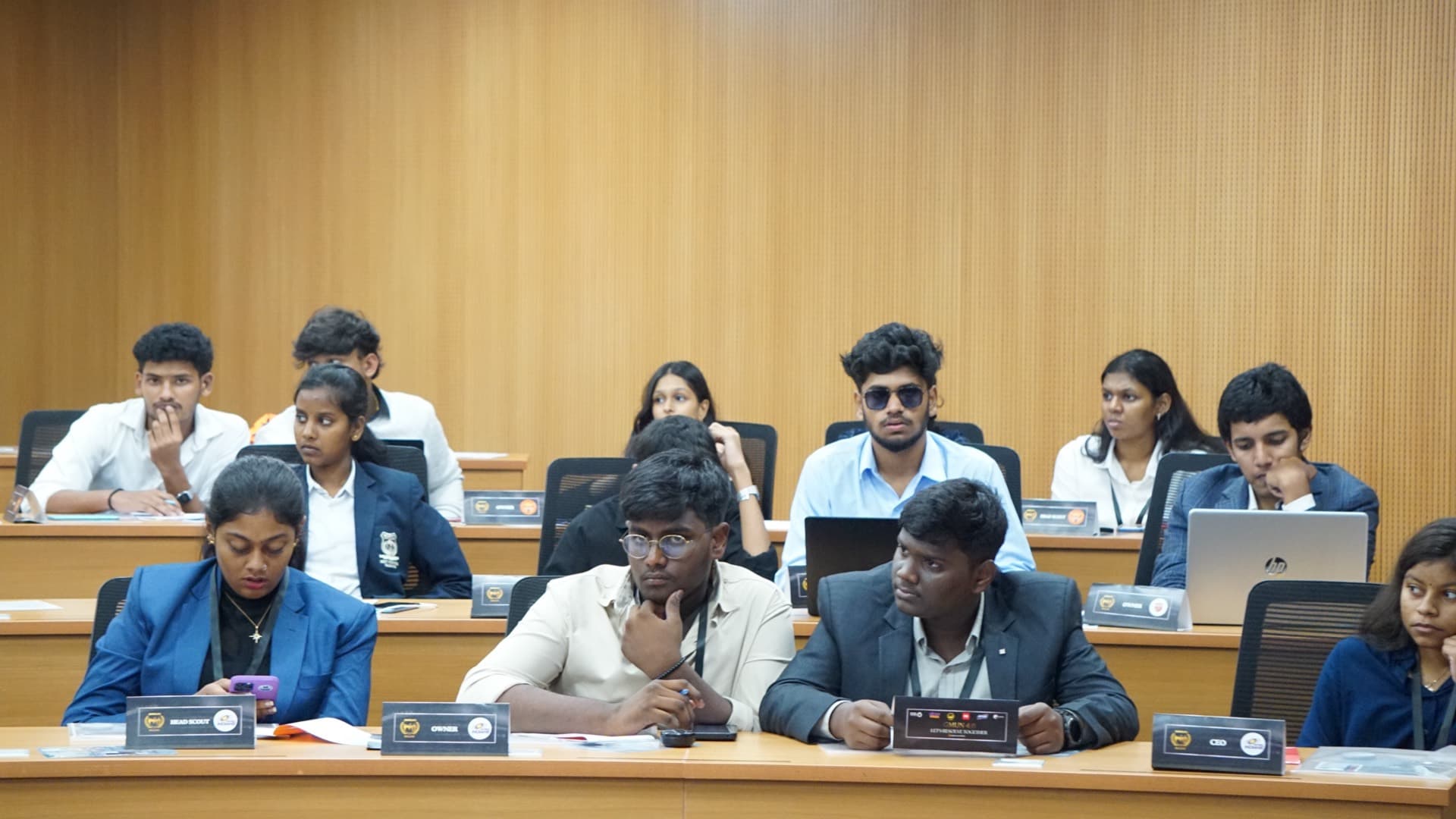 Delegates seated at committee desks with placards