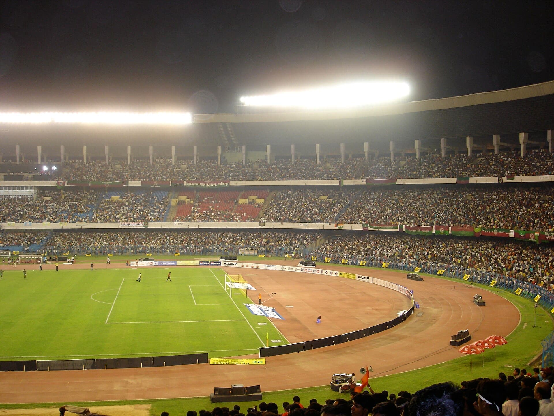 A floodlit football match at Salt Lake Stadium, Kolkata