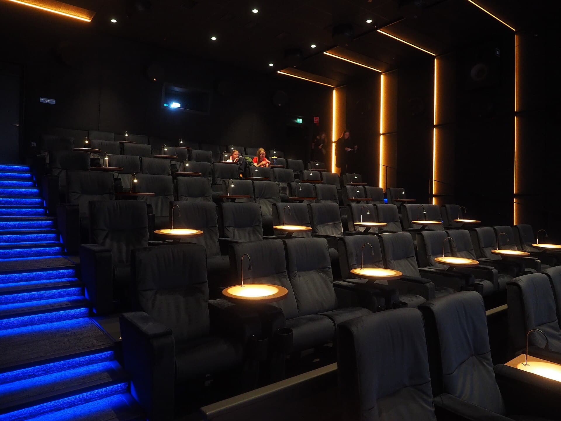 A darkened cinema auditorium with rows of seats