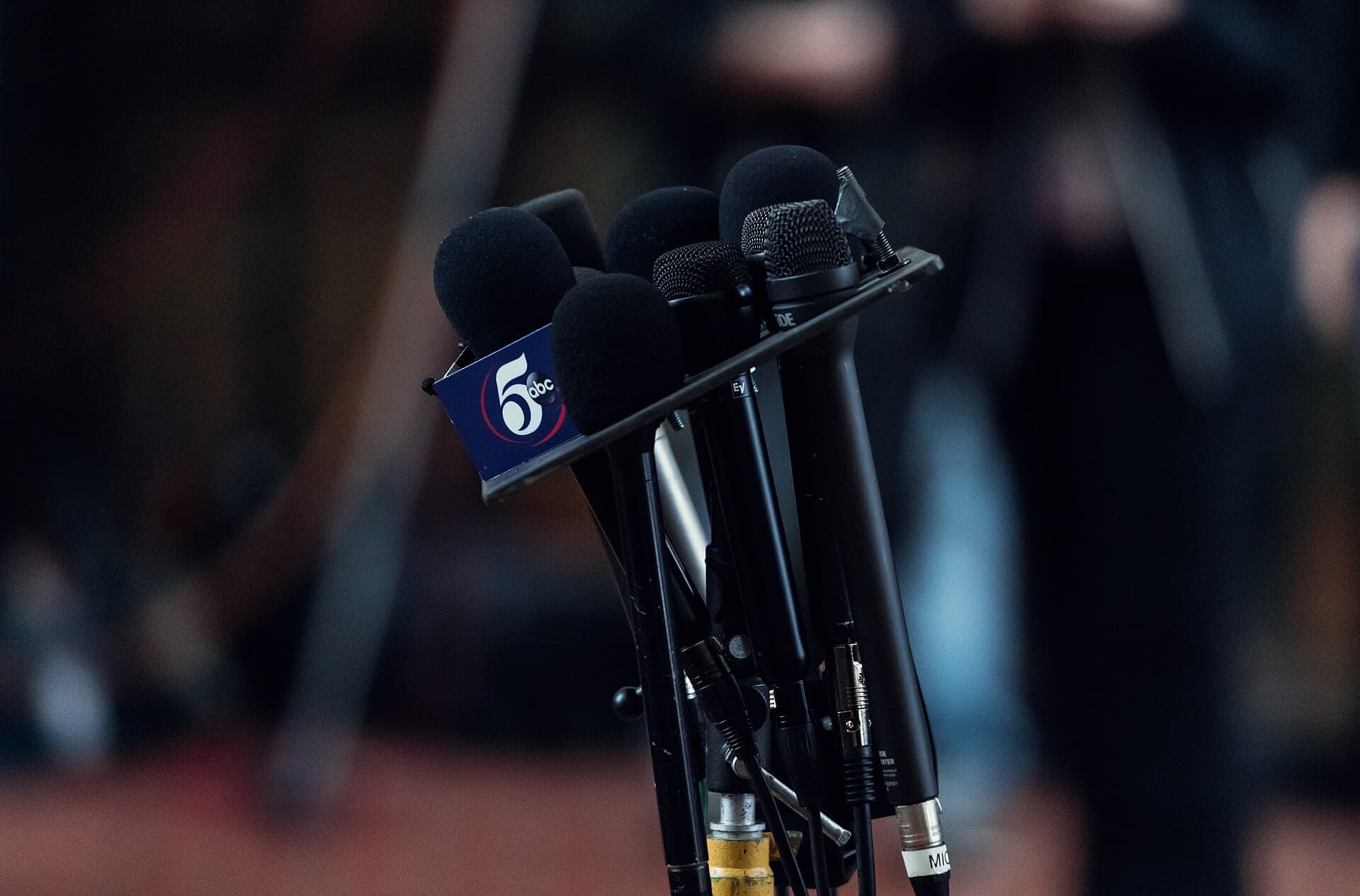 A cluster of news microphones at a press conference